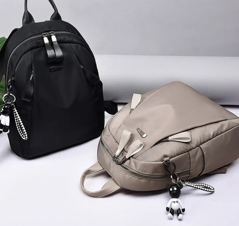 Medium square fashion rucksack in Oxford cloth, shown in red, with internal phone and ID pockets.