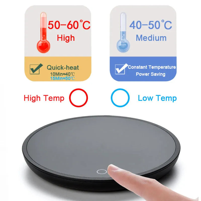 Black circular mug warmer with temperature switch, 12cm in diameter, on a desk next to a coffee cup.