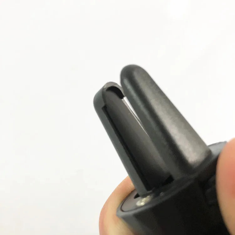 Black car air vent phone holder with magnetic smartphone attachment mounted on vehicle ventilation outlet