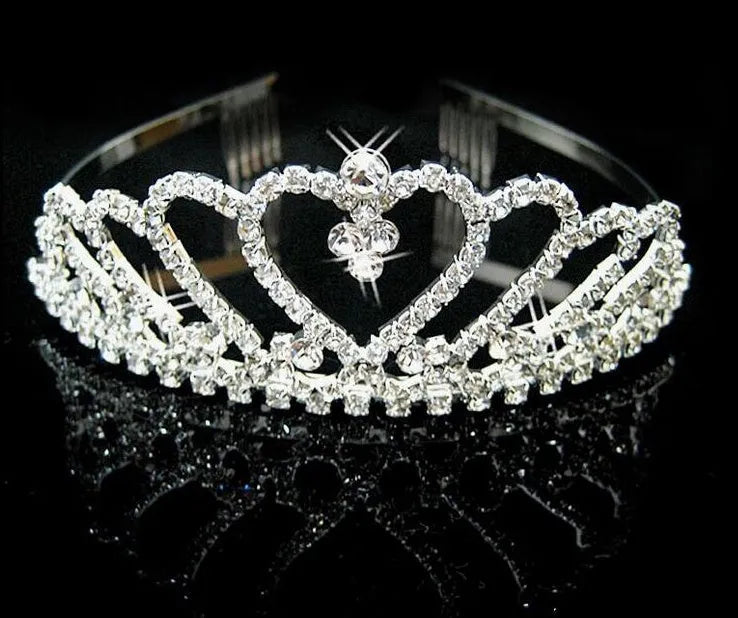 Princess crown hair pin in gold-tone metal with faux gemstones, a bridal hair accessory for wedding hairstyles.