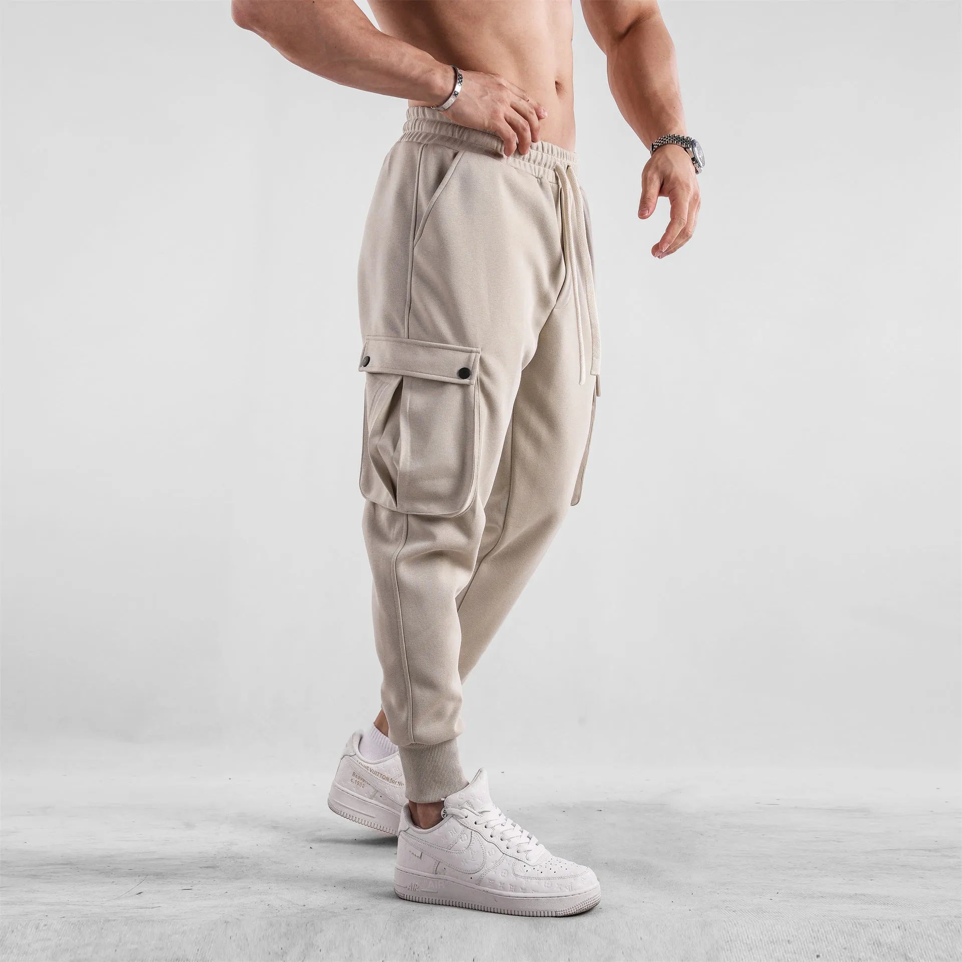 Men's loose fit American sports trousers with ankle ties in apricot colour showing multi-pocket design
