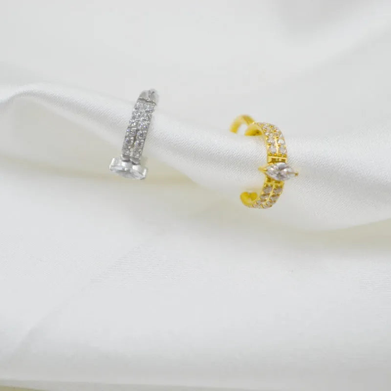 Close-up of a heart-shaped zirconia earring on a 316L steel post in silver tone.