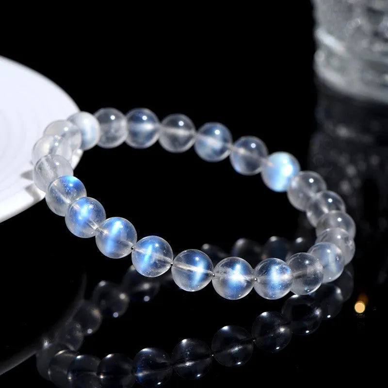 Natural cream body blue moonlight crystal bracelet with matte finish on a wrist.