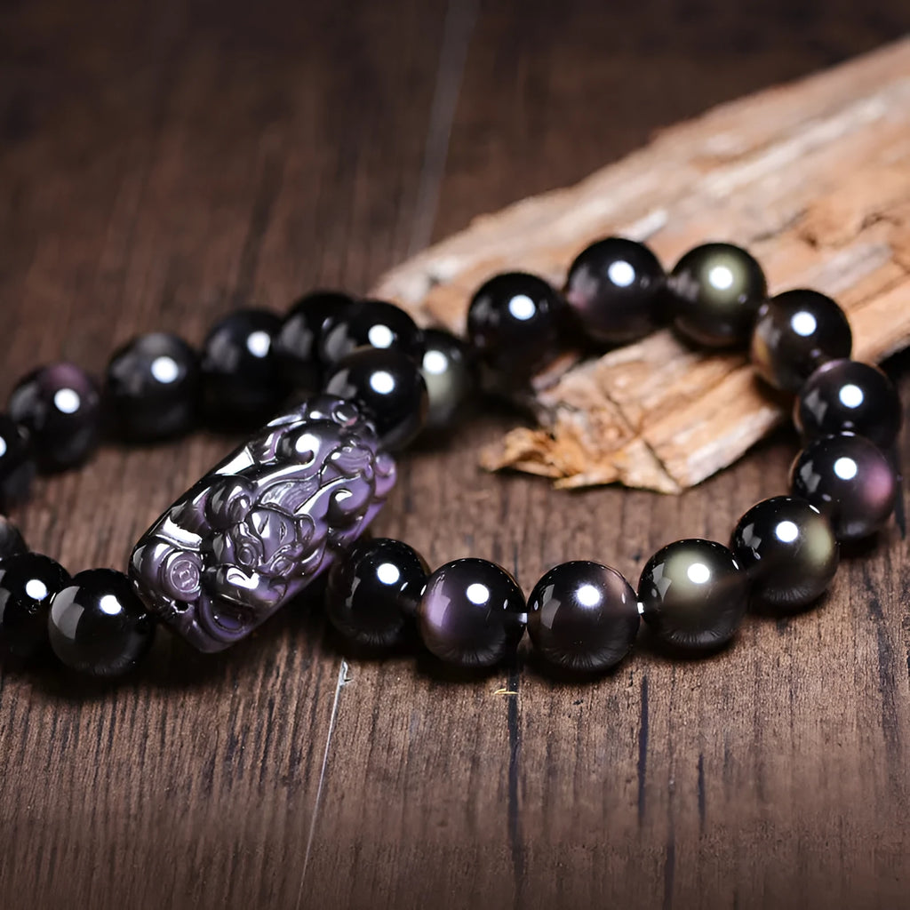 Polished natural icy obsidian Pi Xiu bracelet with ethnic geometric design