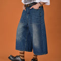 Men's loose-fit straight-leg denim shorts in blue, shown on a hanger.