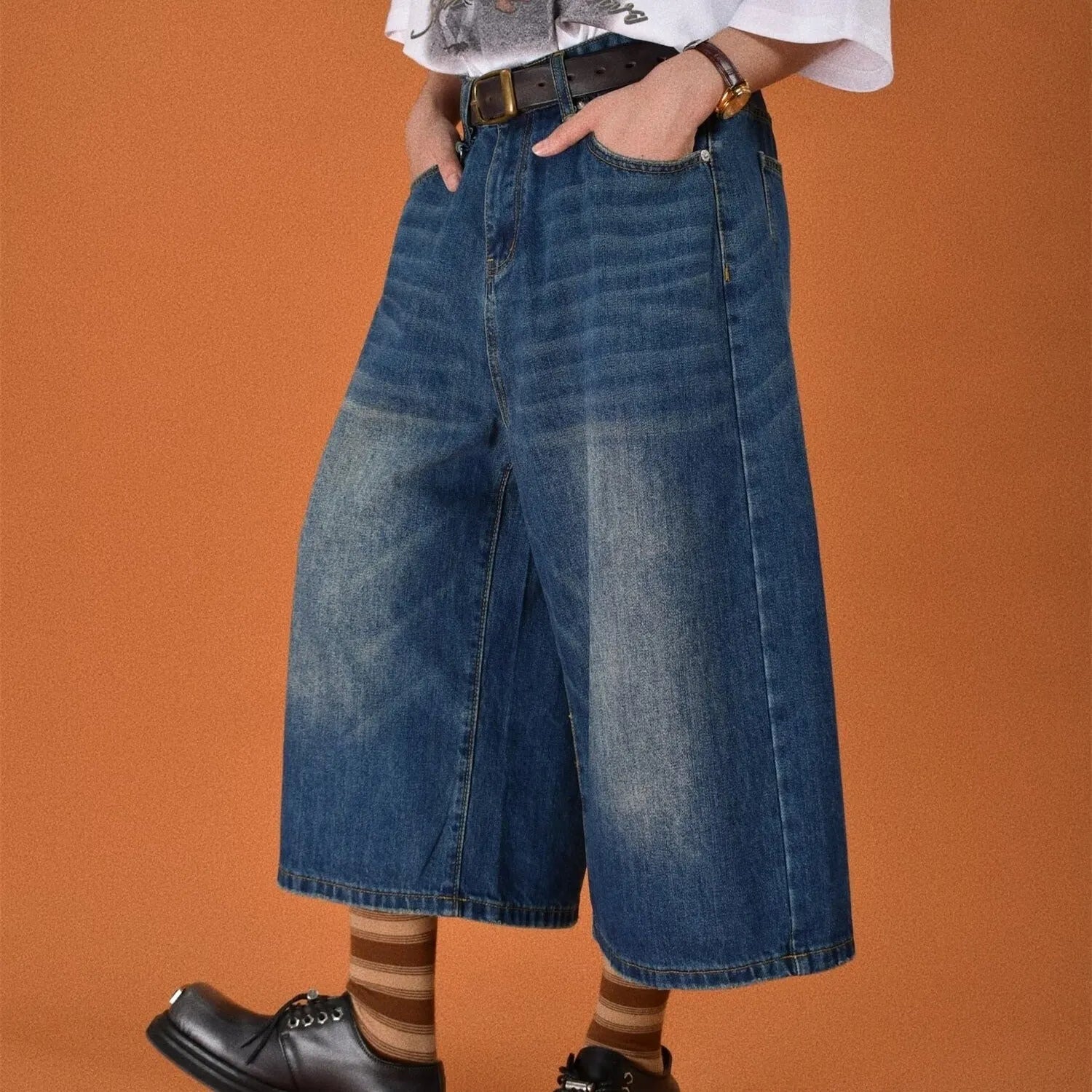 Men's loose-fit straight-leg denim shorts in blue, shown on a hanger.