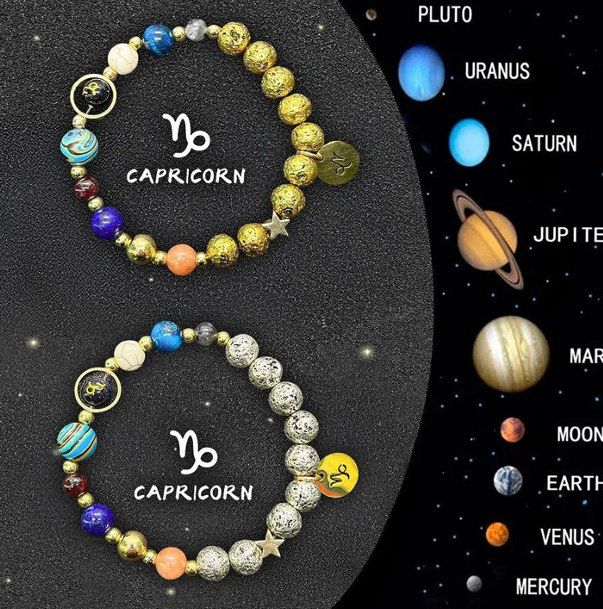 Two natural stone beaded bracelets with zodiac designs on a wooden surface