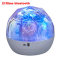 Compact plastic starry sky projector lamp showing cosmic projection on wall.