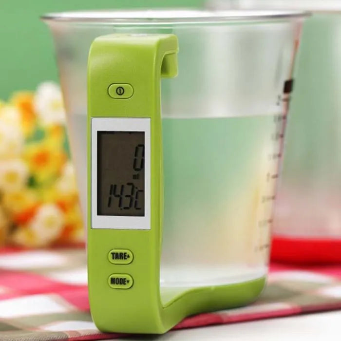 Green digital measuring cup scale with LCD display in handle on white background, 185mm size