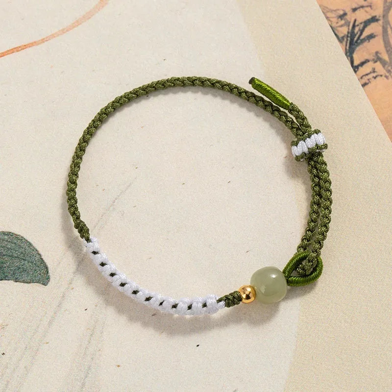 Colourful national fashion bracelet with Hetian jade and sterling silver carrying strap on a neutral background