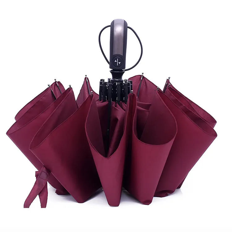 Automatic triple folding business umbrella in black colour showing steel ribs and rubber handle