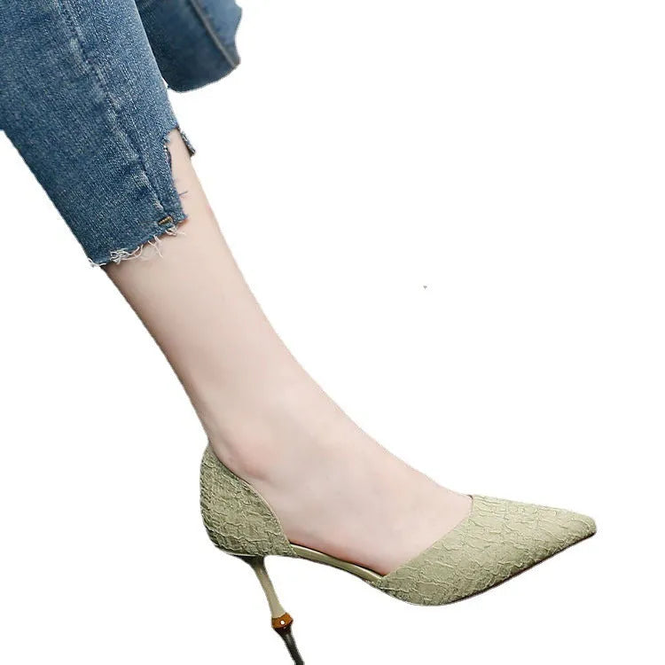 Women's black pointed-toe stiletto high heels with a stitched leather detail and rubber sole.