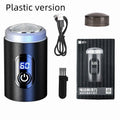 Black portable USB rechargeable shaver with cleaning brush and cable on a white background.