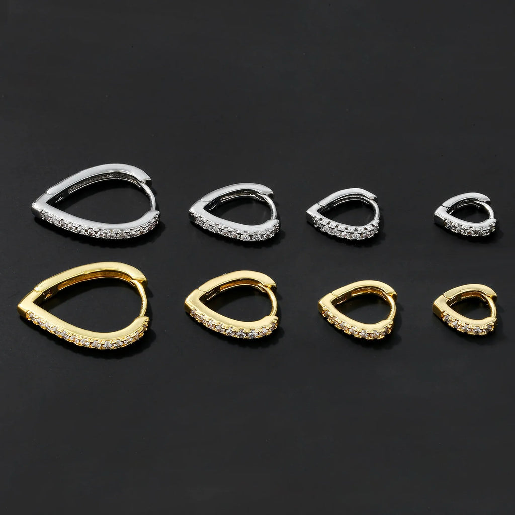Geometric gold tone love heart clip-on earring for women on a white background.