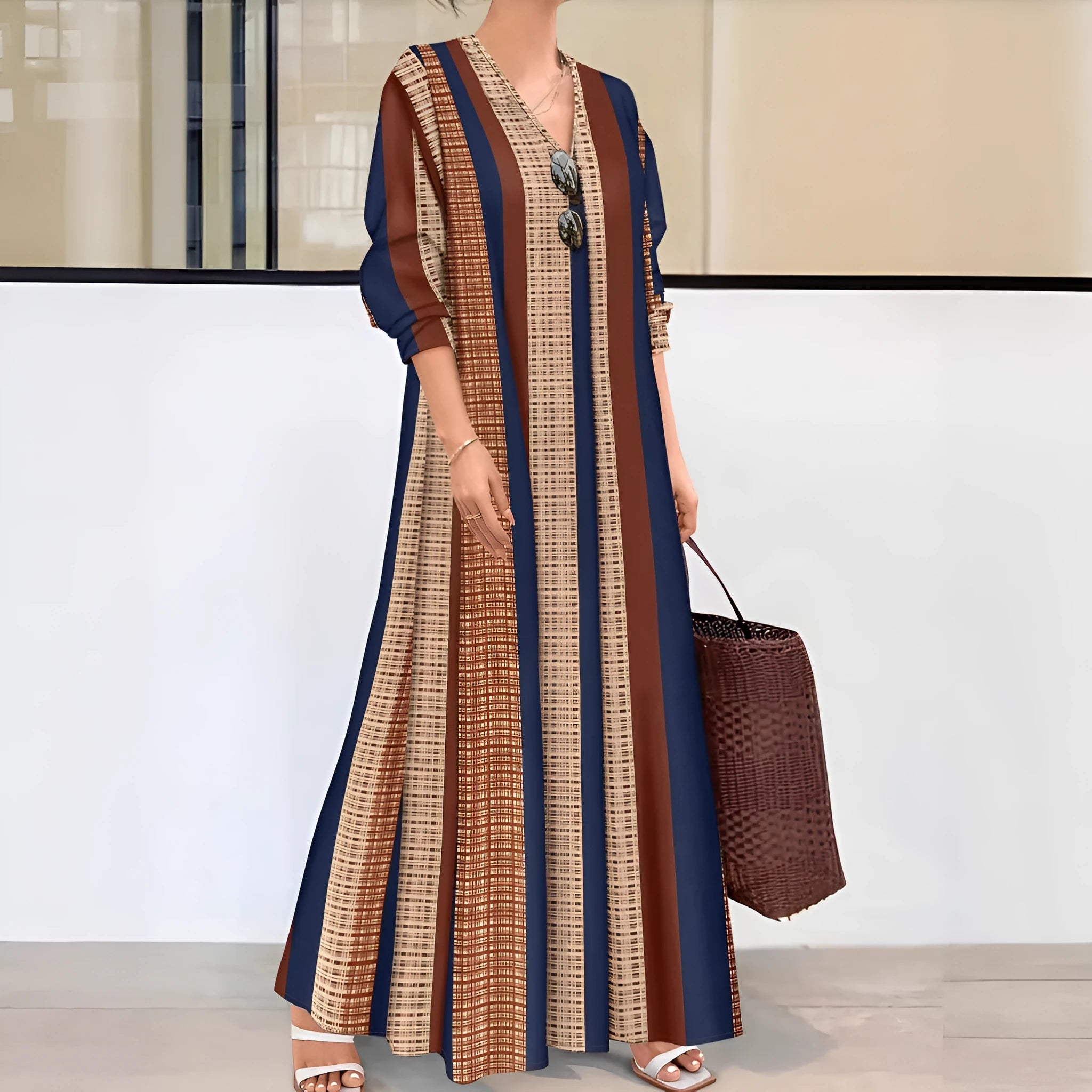 Camel coloured striped V-neck long sleeve dress with an A-line skirt on a hanger.
