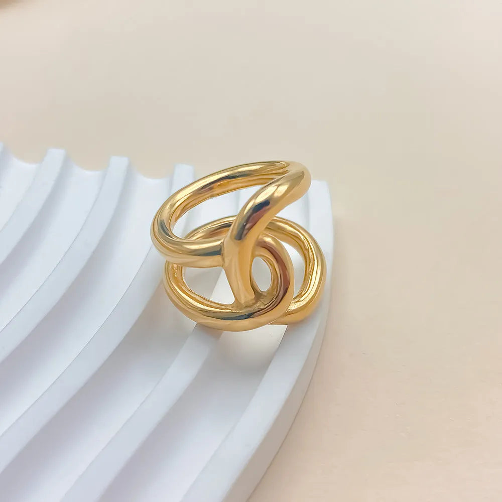 Women's stainless steel adjustable ring with knotted geometric U-shape design in gold or steel colour.