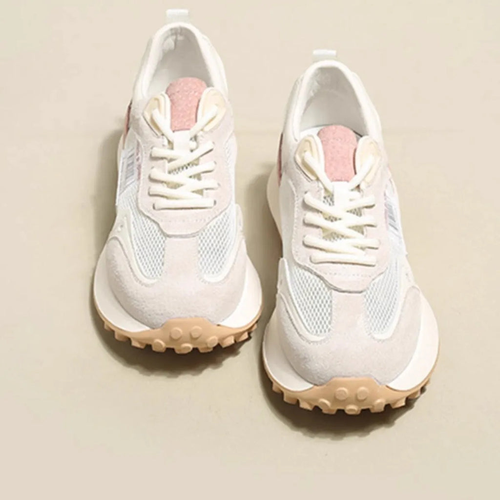 Women's grey retro low-top sneaker with round toe and flat rubber sole on a neutral background.