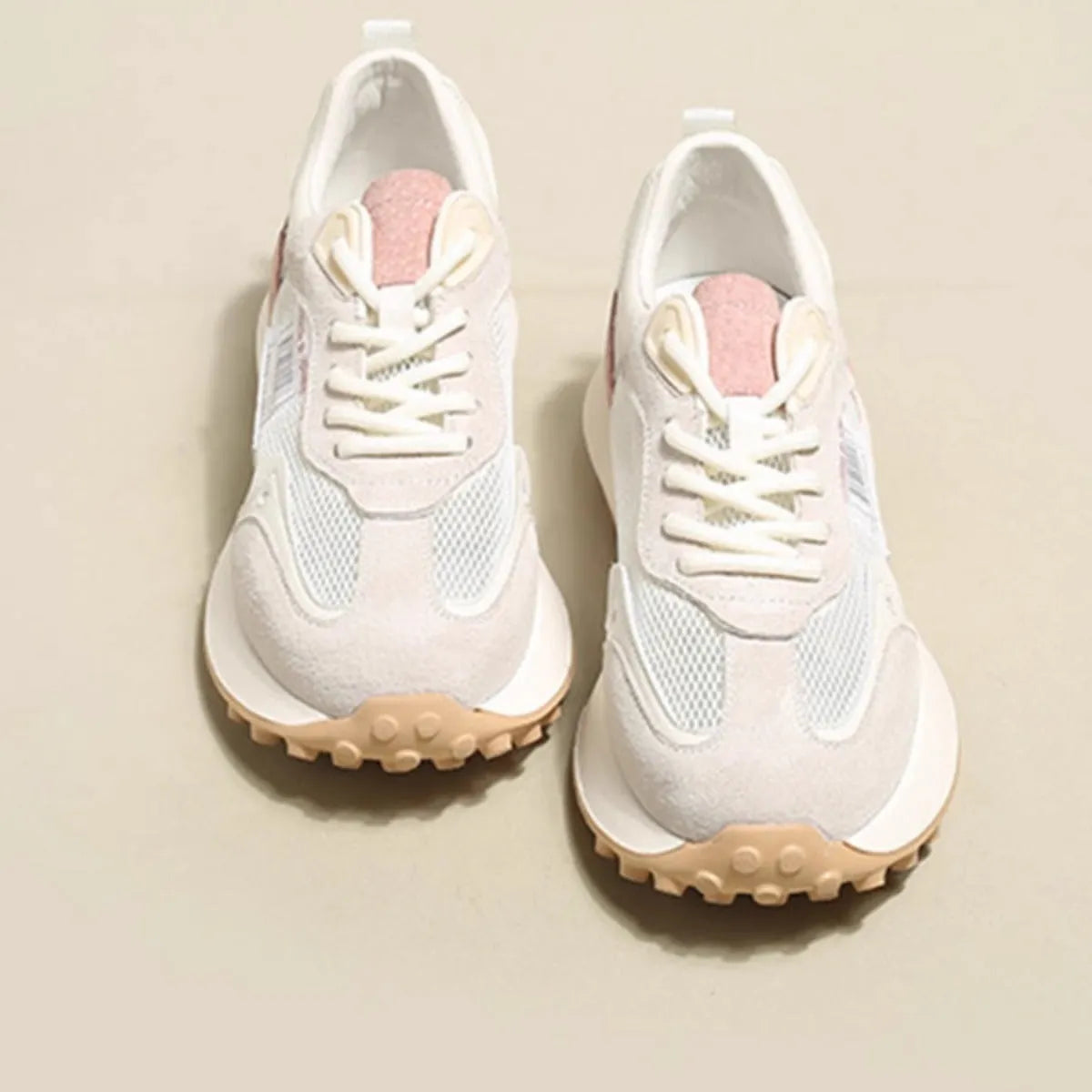 Women's grey retro low-top sneaker with round toe and flat rubber sole on a neutral background.