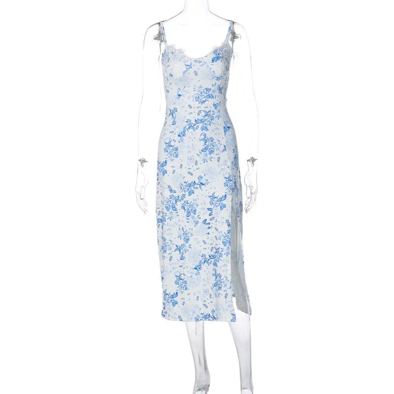 Women's long dress with lace flower print, high split, and suspender straps in blue colour.