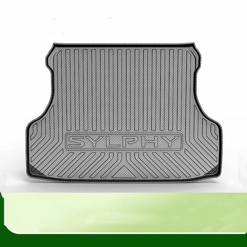Black carbon fibre pattern TPE car boot liner mat fitted in a hatchback trunk.