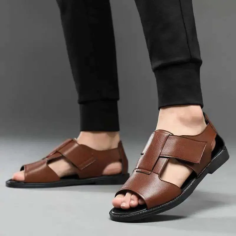 Men's black leather casual Roman sandals with an open toe and rubber sole on a neutral background.