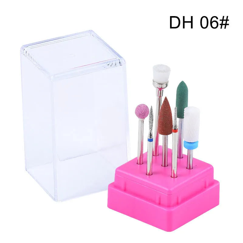Seven tungsten steel nail drill bits arranged next to a brush inside a transparent case