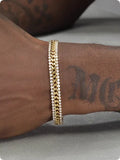 Gold electroplated titanium steel tennis bracelet with artificial gemstones for men and women.