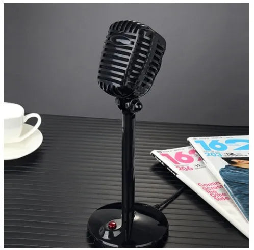 Black USB computer microphone with adjustable stand on desk for recording
