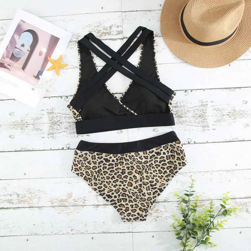 Women's leopard print one-piece swimsuit with V-neck and cross banded design.