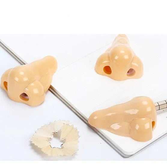 Flesh colour plastic pencil sharpener showing geometry design and large nostril hole