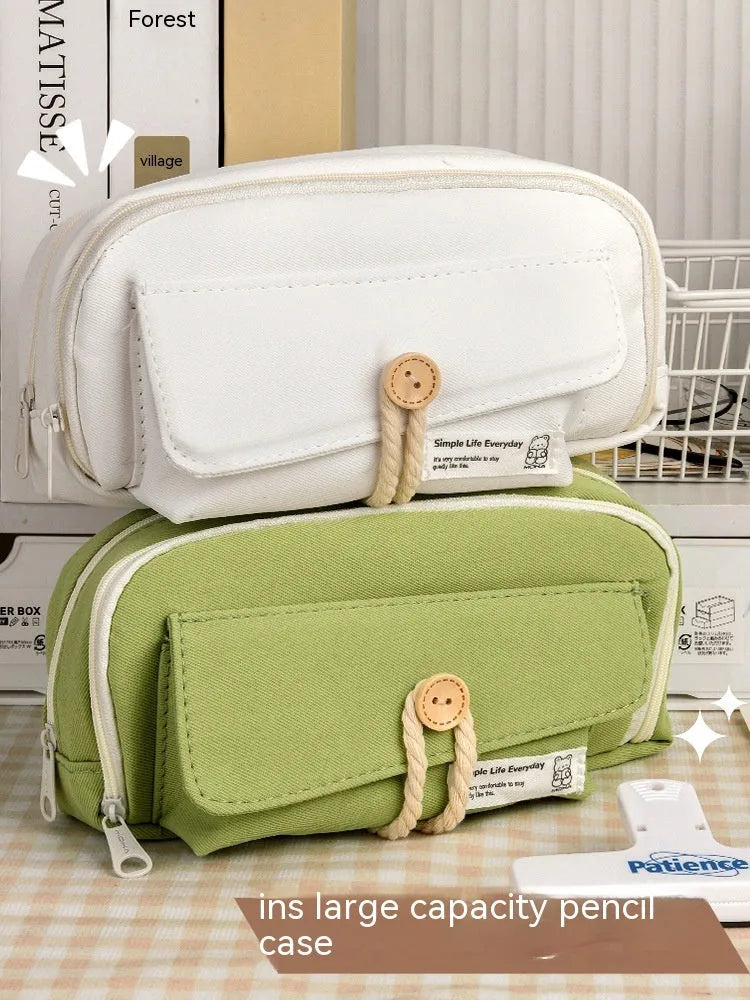 Korean-style canvas pencil case with button closure storing approximately 80 pens