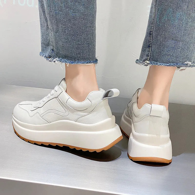 Beige women's low-top leather casual shoes with cross strap and a distinctive English muffin heel.