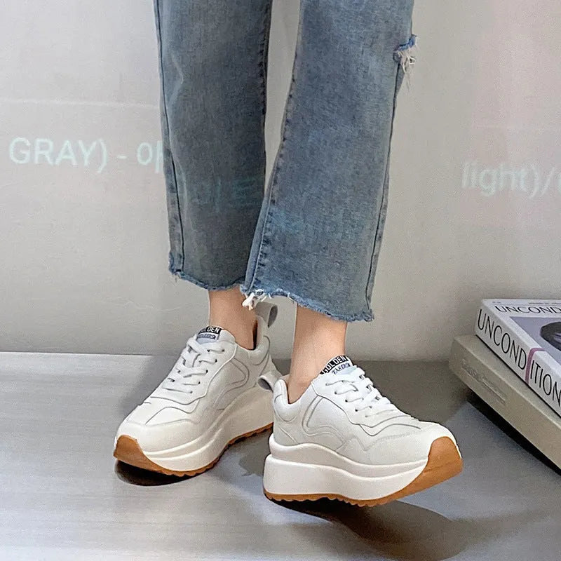 Beige women's low-top leather casual shoes with cross strap and a distinctive English muffin heel.
