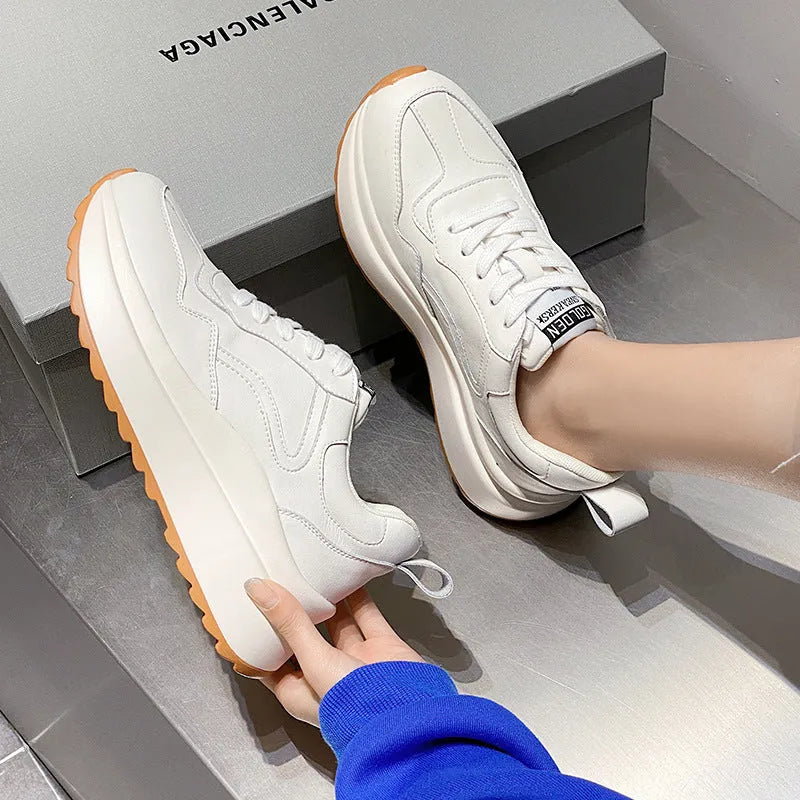 Beige women's low-top leather casual shoes with cross strap and a distinctive English muffin heel.