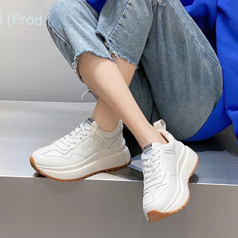 Beige women's low-top leather casual shoes with cross strap and a distinctive English muffin heel.