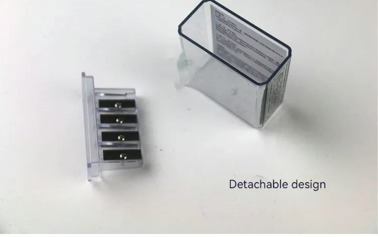 Geometric plastic pencil sharpener with four holes and included screwdriver tool on white background.
