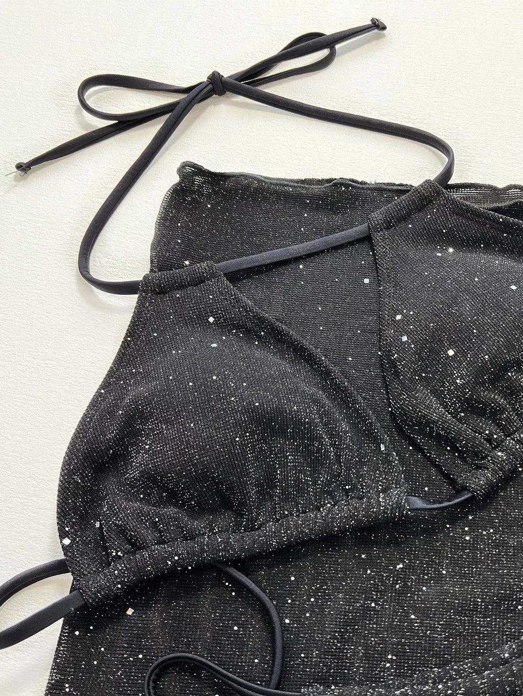 Black polyester bikini three-piece swimsuit set with triangle top and matching shorts