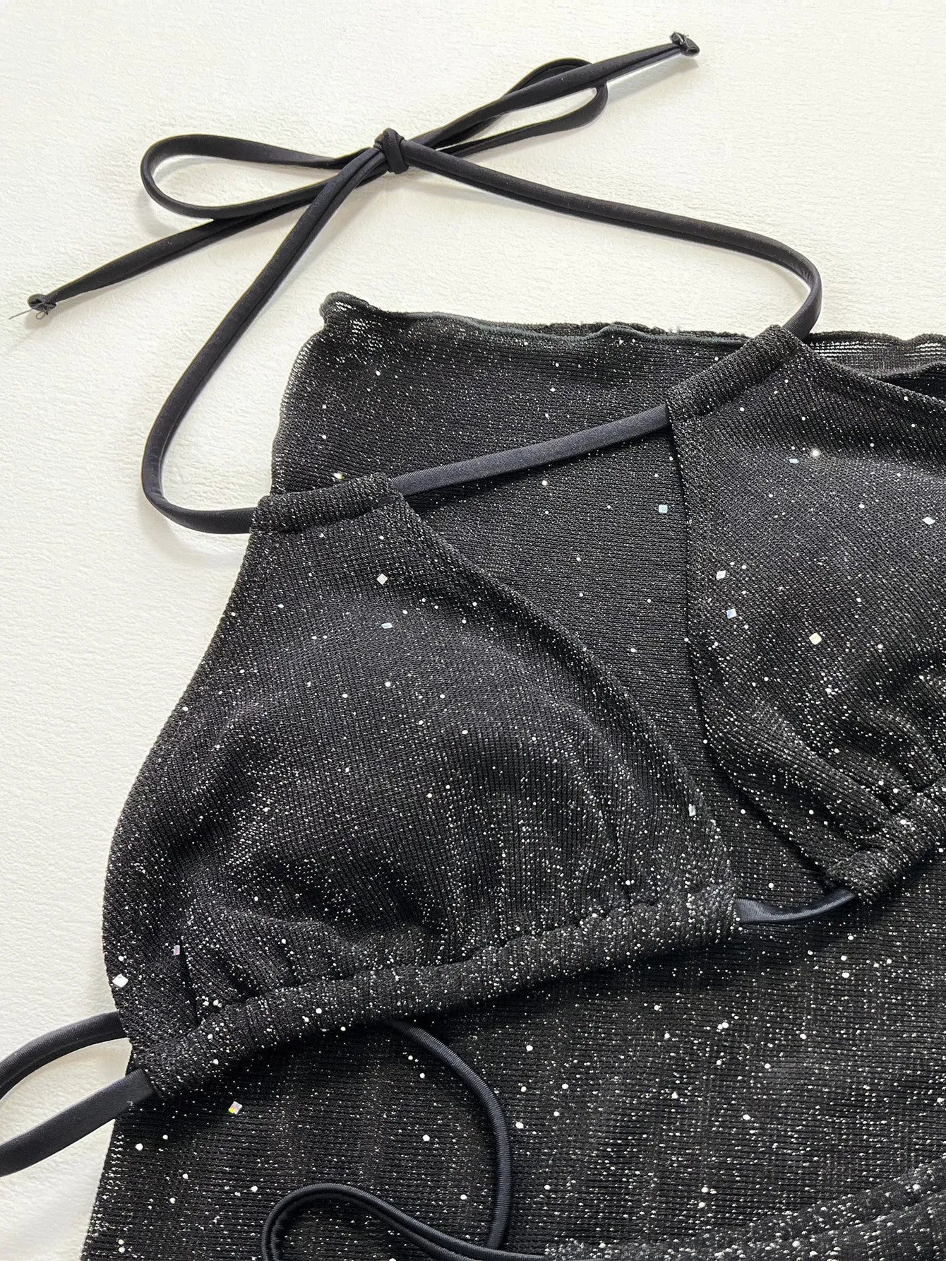 Black polyester bikini three-piece swimsuit set with triangle top and matching shorts