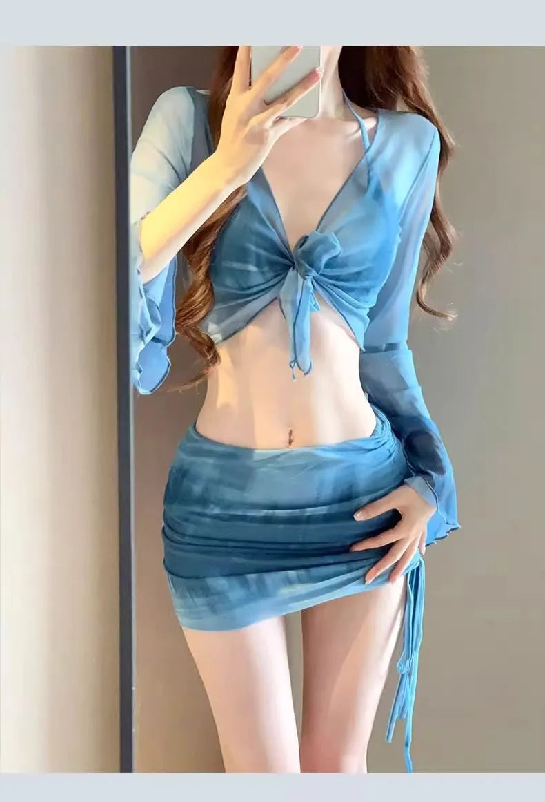 Women's blue high-waist bikini set with shirt, bra, underwear, and skirt laid flat.