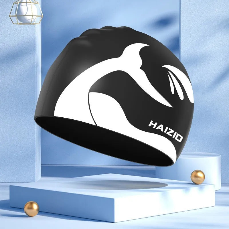 Silicone swim cap with whale tail pattern and moulded ear protectors in a choice of colours.