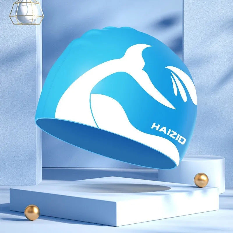 Silicone swim cap with whale tail pattern and moulded ear protectors in a choice of colours.