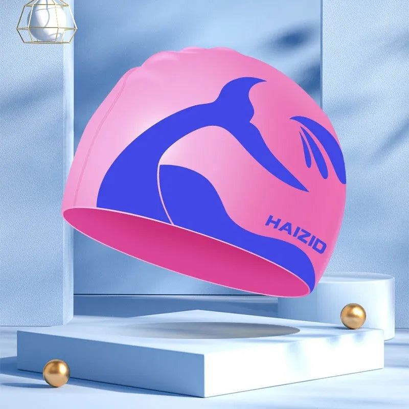 Silicone swim cap with whale tail pattern and moulded ear protectors in a choice of colours.