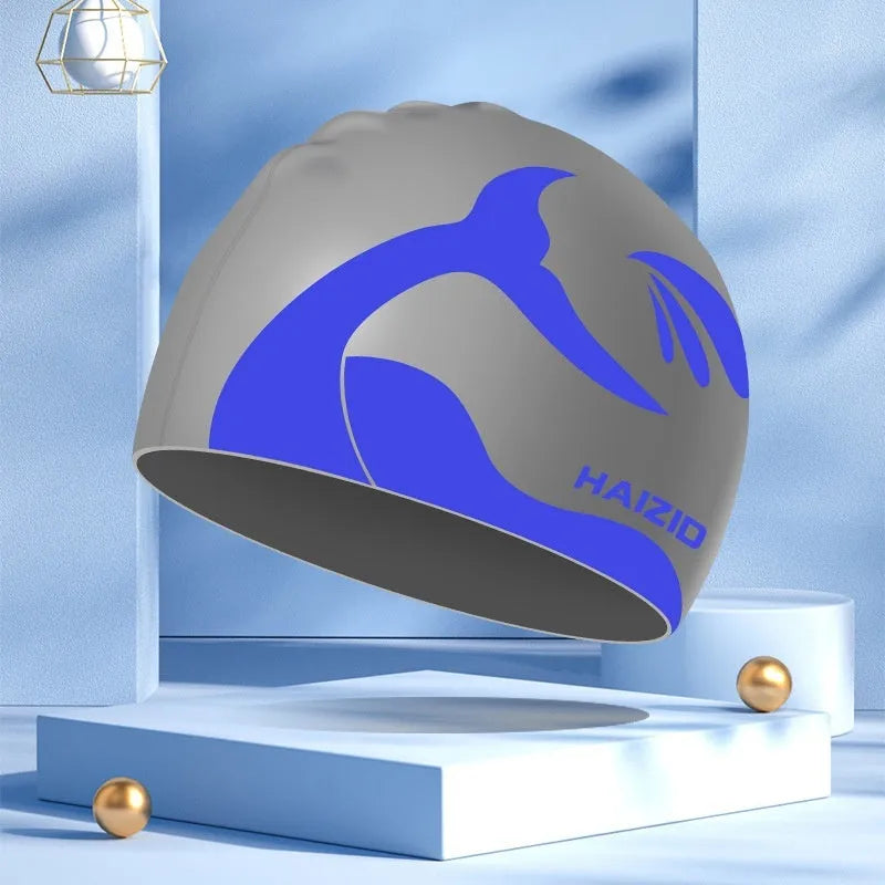 Silicone swim cap with whale tail pattern and moulded ear protectors in a choice of colours.