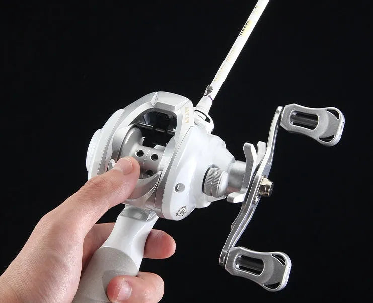 Small white ET Drop Wheel micro bait casting fishing reel on a neutral background.