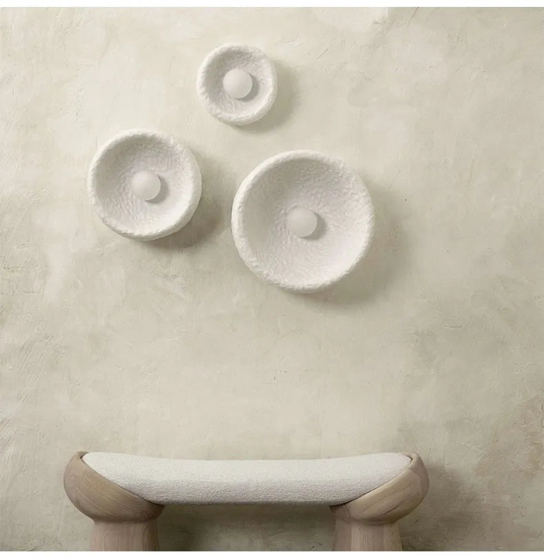 Japanese-style minimalist wall lamp with resin shade in three diameter sizes on white wall