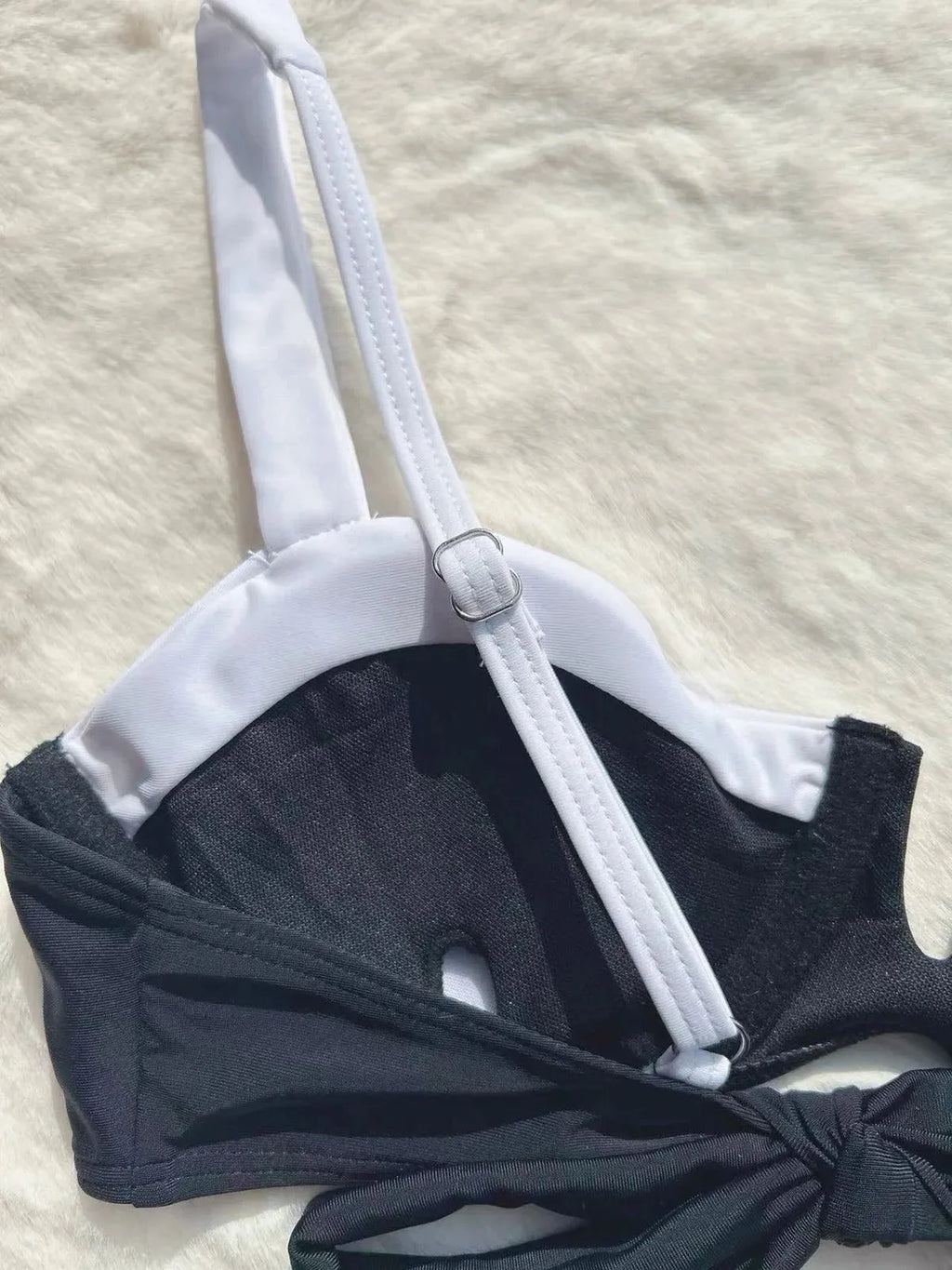Black low waist women's bikini swimsuit with stitching split detail on the pants.