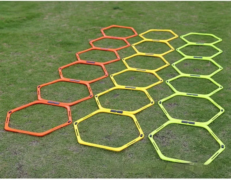 Set of six yellow, green, and orange foldable hexagonal football agility training rings laid flat.