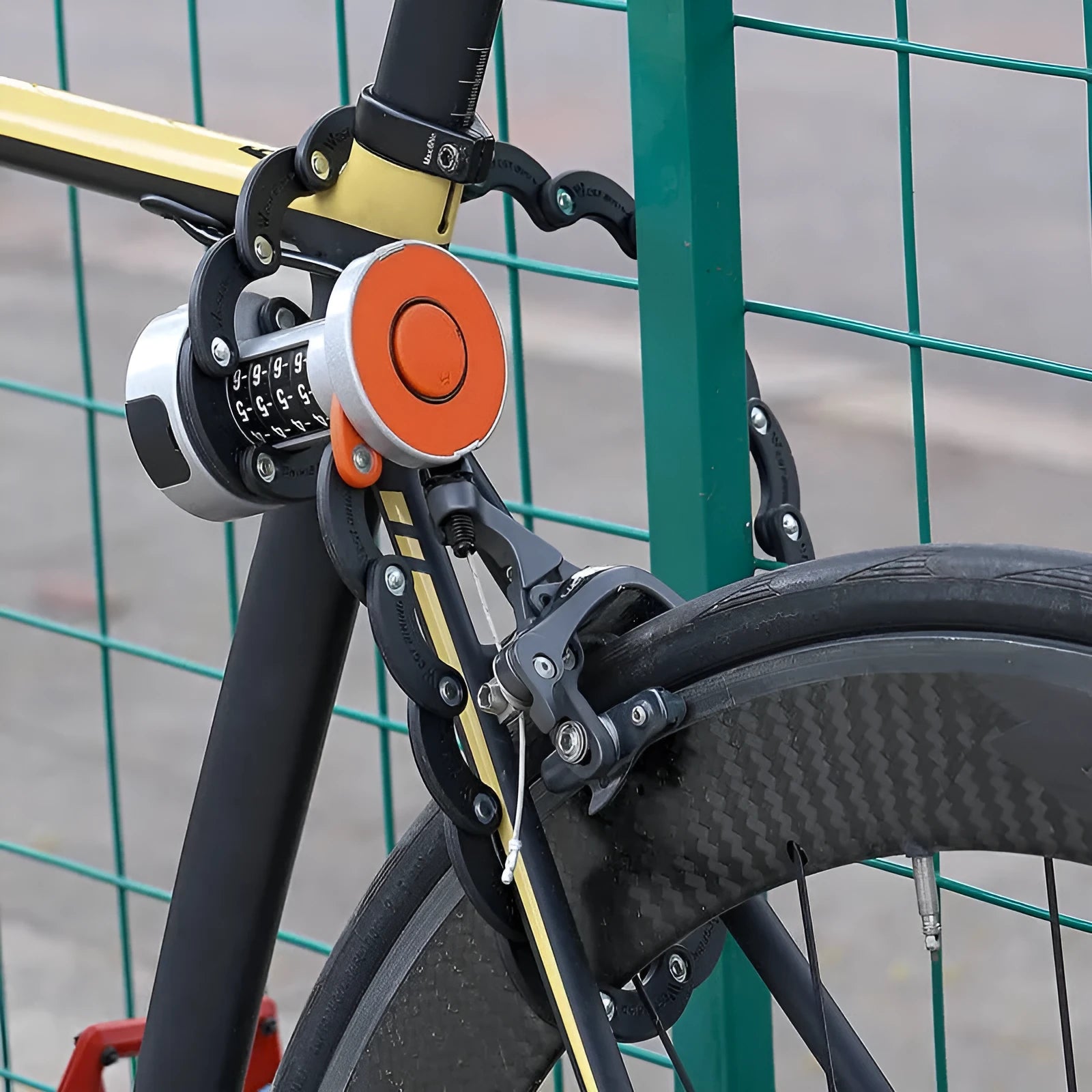 Black bicycle folding lock extended to 30cm length showing interlocking steel segments and zinc alloy housing