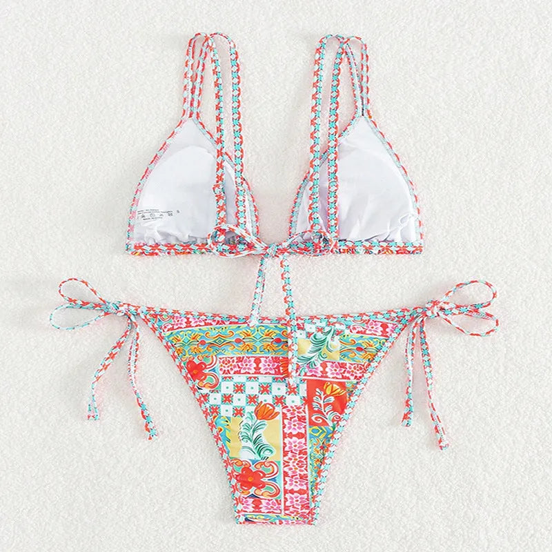 Women's lace-up split swimsuit in picture colour, showing backless brief design for swimming.