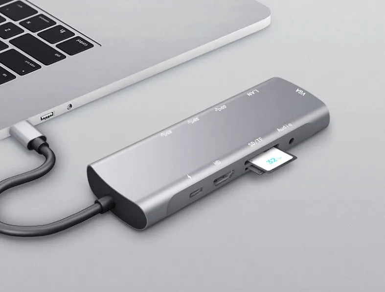 Grey USB-C docking station with aluminium alloy shell showing HDMI, VGA and USB ports